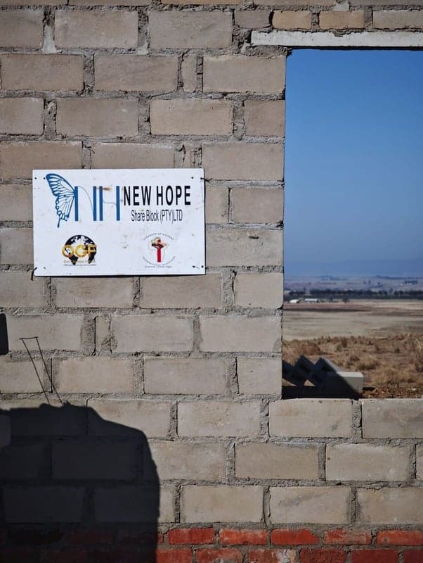 New Hope sign on a brick construction wall