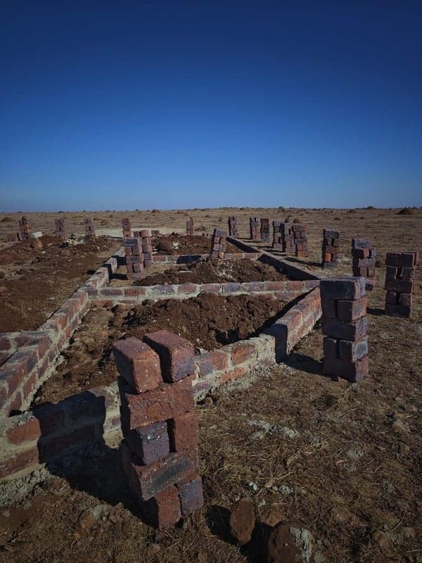Foundation brickwork in an open field