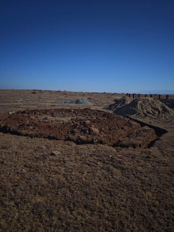 Excavation and foundation work under a blue sky