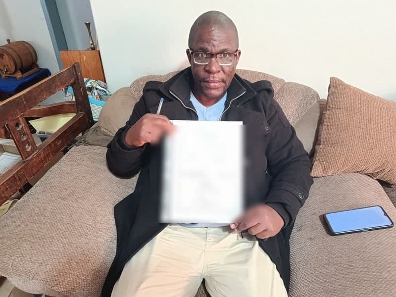 TC Ngwenya holding a New Hope share certificate