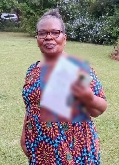 New Hope shareholder holding a certificate in a garden