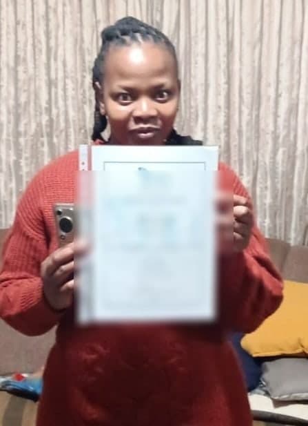 New Hope shareholder holding a certificate indoors